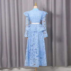 Back view of light blue embroidered lace dress with bell sleeves and ruffles.