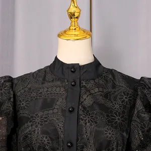Close-up detail of black embroidered vintage socialite dress with buttons on neck