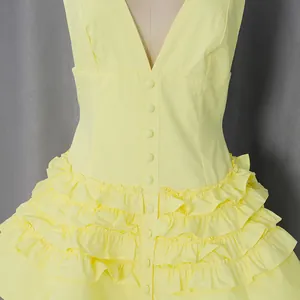 Close-up detail showing the yellow French retro halter neck tiered dress with ruffle layers