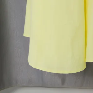 Detail of the hem on a French vintage tiered yellow dress for summer