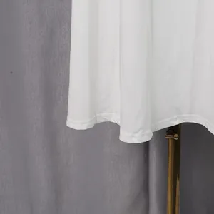 Close-up detail of the hemline and stitching on a white retro lace long dress garment