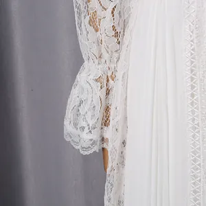Detailed shot of intricate vintage white lace sleeves and pleated fabric on a dress