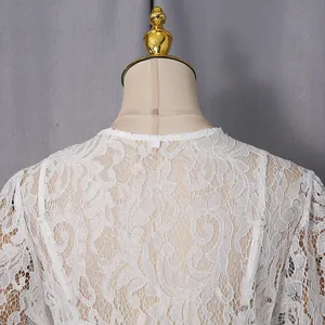 Close-up of intricate white floral lace texture on a vintage style dress