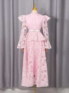 Elegant vintage pink lace maxi dress with intricate floral embroidery and flared sleeves