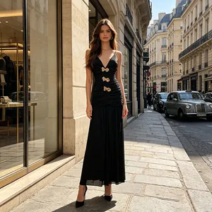 Elegantes schwarzes plissiertes Abendkleid mit goldenen Schleifenakzenten im Freien