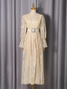 Elegant vintage cream lace maxi dress with long sleeves and jeweled belt on mannequin.