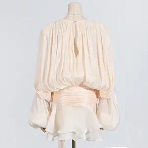 Back view of elegant pleated mini dress with long lantern sleeves and sash belt