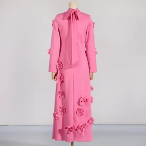 Back view of pink A-line maxi dress with 3D floral appliqués and decorative neck bow tie