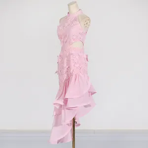 Side view of pink sleeveless dress showing floral appliqué and tiered ruffle detail.