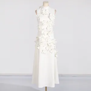 Elegant white sleeveless maxi dress with 3D floral applique detail on a mannequin