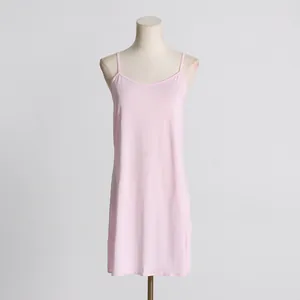 Elegant light pink spaghetti strap slip dress shown on a minimalist mannequin torso