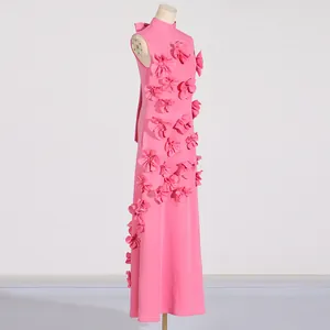 Side detail view of an elegant pink sleeveless maxi dress with 3D floral appliqués
