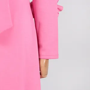 Detailed close-up showing the sleeve cuff and soft pink fabric texture of this elegant dress