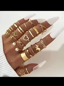 Detail shot of a 22-piece gold-tone adjustable ring set featuring heart and butterfly motifs
