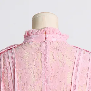 Detailed macro shot of elegant pink floral lace fabric and back zipper on French dress