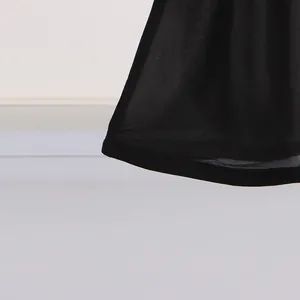 Detailed close-up showing the lightweight black sheer mesh fabric hem of a summer holiday maxi dress