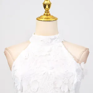 Close-up detail of elegant white floral lace embroidery on high-neck halter dress