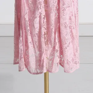 Close-up showing the intricate floral embroidery on the hem of this pink lace dress