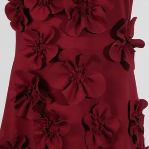 Detailed close-up shot of 3D fabric flower appliqués on an elegant burgundy dress.