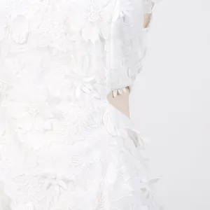 Detailed macro shot of white floral lace embroidery on summer resort-style dress