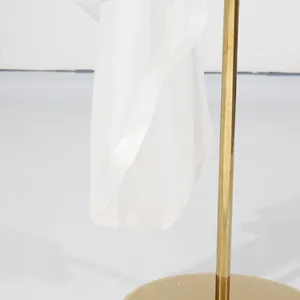 Detailed close-up view of the white asymmetrical dress hem showing fabric texture
