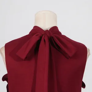 Detailed back view of a burgundy sleeveless dress featuring an elegant large bow knot