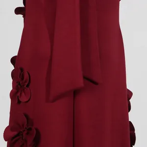Detail of burgundy French style dress with stand collar tie and 3D floral appliqués