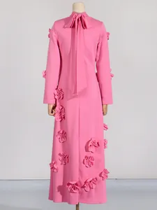 Elegant pink long-sleeved A-line dress with decorative 3D floral accents, back view