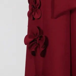 Close-up detail of exquisite 3D floral appliqués on a burgundy French style vacation dress