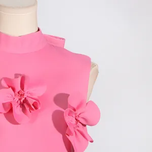 Macro view of 3D flower patchwork on pink elegant stand collar sleeveless long dress