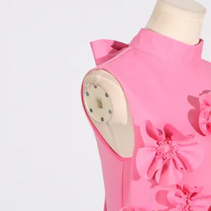 Detail of pink sleeveless long dress featuring 3D floral appliqués and standing collar design.