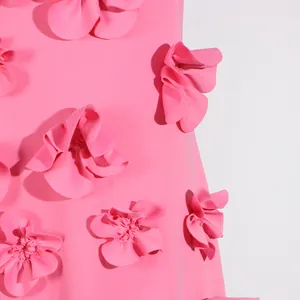 Close-up of 3D floral appliques on an elegant pink sleeveless long dress design