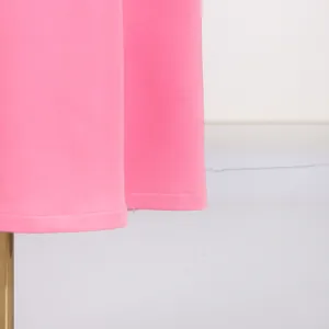 Detail view of the neatly stitched hemline on this elegant pink sleeveless maxi dress.