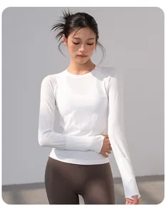 Detailed view of women's white breathable long-sleeve yoga top with fine ribbed texture