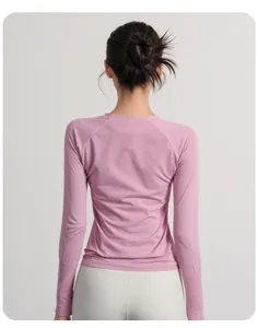 Back view of slim-fit pink long-sleeve yoga shirt for women showing breathable fabric detail.