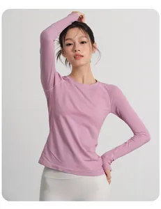 Close-up of pink long sleeve yoga top showing slim fit and ribbed texture
