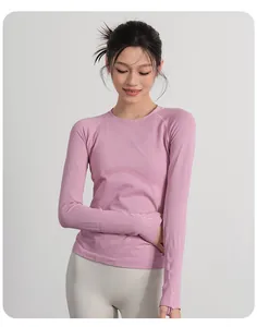 Detailed view of women's pink ribbed long-sleeve yoga top with functional thumbholes