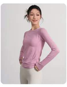 Breathable pink long-sleeve yoga top for women with thumb holes and slim fit design