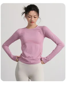 Slim fit long-sleeve yoga top for women in dusty rose featuring thumbholes and ribbed texture.