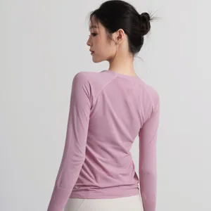 Slim fit pink long sleeve yoga top for women, breathable athletic wear for Pilates.