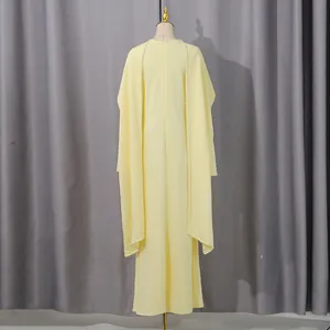 Back view of elegant yellow high waist dress featuring a pearl-edged shawl detail