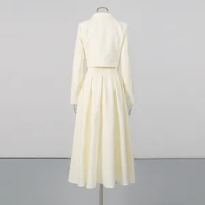 Back view of elegant cream beaded jacket and high-waisted pleated midi skirt set