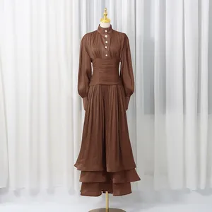 Vintage brown pleated maxi dress with lantern sleeves and tiered ruffle hem detail.