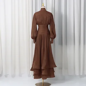 Elegant brown long dress with lantern sleeves and ruffled hem, rear view details.