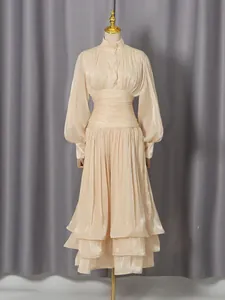 Elegant vintage champagne dress with lantern sleeves and tiered ruffled hem detail