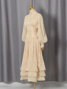 Elegant champagne lantern sleeve maxi dress with tiered ruffle skirt and slim waist