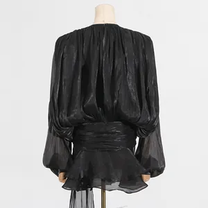Back view of black ruffled mini dress with gathered waist and sheer long sleeves