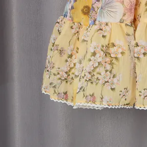 Close-up detail of French style floral print dress with white lace ruffled edge