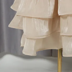 Close-up of shimmery champagne tiered layers on an elegant French style banquet dress