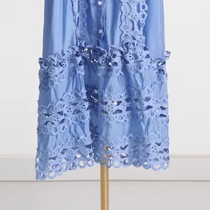 Détail de robe style français bleue avec broderie complexe et ourlet en dentelle ajourée